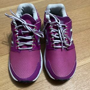Pair of women’s bright pink New Balance tennis shoes, size 7 1/2.